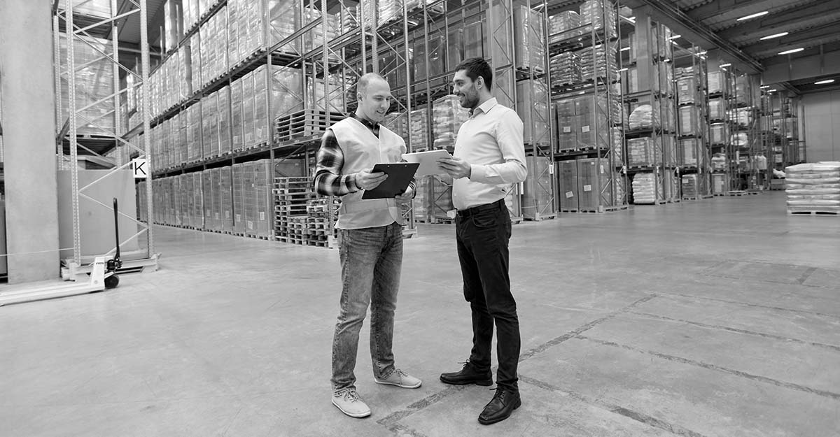 carrier and business owner reviewing full truckload freight quotes in warehouse